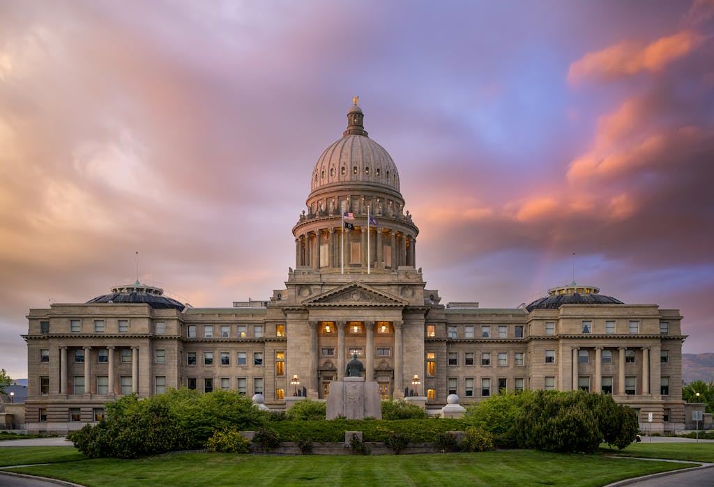 Exterior of famous Idaho State Capitol building located in America under colorful sky at sunrise